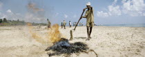 A government-led clean-up operation takes place on Auroville beach approximately one month after the Indian Ocean Tsunami hit the south Indian coastline on December 26th 2004.firebonfiresmokeworke...