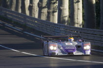 Number 8 purple and silver Audi R8 race car with advertising and logos  exiting Tetre Rouge.motor racing Automobile French Western Europe Automotive Automvil Cars Eight European Motorcar Automobiles...