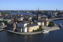 View of the town and waterfront from the City Town Hall. Boats moored in front of buildings.