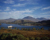 Sheildaig Village with cruise ship  Hebridean Princess  in front of mountain. Upper Loch Torridon