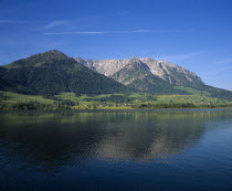 East of Kufstein  Zahmer Kaiser. Overlooking lake  houses at the base of the tree covered mountain. Beyond Walchsee.  1997 meters  6540 feet