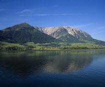 East of Kufstein  Zahmer Kaiser. Overlooking lake  houses at the base of the tree covered mountain. Beyond Walchsee.  1997 meters  6540 feet