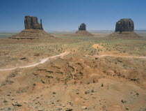 Rock formations surrounded by desert and dirt roads
