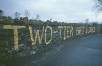 Falls Road. Beechmount Area. Anti British grafitti on a wall saying Two Tier British Justice
