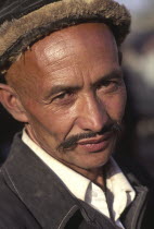 Head and shoulders portrait of Tajik man