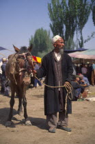 Tajik men with a horse for sale