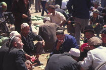 Market Vendors eating water melon