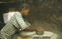 Near Garango.Young girl grinding grain. girls called Mariam