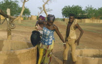 Women collecting water from a well