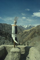 Figure of guardian of death on monastery roof.