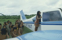 Xikrin Indian children crowding around small plane.Brasil Kaiapo Brazil Kayapo Mebengorke