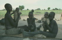 Dinka mother with twin babies and two older children.