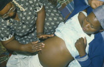 Traditional midwife massaging patient.
