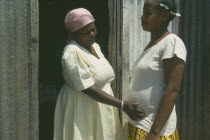Seventy year old traditional birth attendant with thirty five year old woman during her fourth pregnancy.