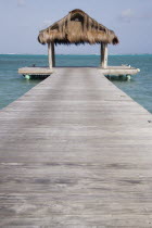 The jetty on Jambu Beach at Raffles Resort