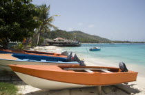 Fishing boats on beach in Britannia Bay with Basils Bar beyond