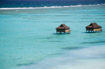 Offshore treatment rooms of the Amrita Spa off Godahl Beach at Raffles Resort with the coral reef beyond