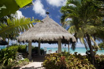 Palapa thatched entrance from hotel jetty at Tamarind Beach Hotel in Charles Bay