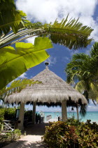 Palapa thatched entrance from hotel jetty at Tamarind Beach Hotel in Charles Bay