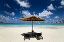 Palapa thatched shelter and sunbeds at Tamarind Beach Hotel in Charles Bay with moored yachtsBeaches Caribbean Resort Sand Sandy Seaside Shore Tourism West Indies Windward Islands  Beaches Caribbean...