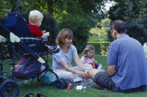 The Bishops Palace Gardens.  Young family having picnic.  Parents with daughter aged three and son aged one and a half in push chair.