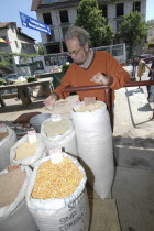 Buyer checking sacks of lentils pulses rice and wheat at the fresh produce marketAgricultural produce available products