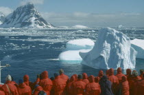 Tourist group looking at iceberg from cruise ship near the Lemaire Channel.