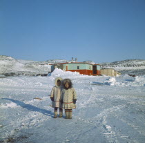 Young Innuit girls outside settlement.