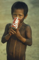 Kayapo child with can of Coca Cola.Brasil First contact Brazil Kaiapo Xikrin Mebengorke