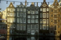 View of traditional houses alongside the Damrak to Dudeezijds Voorburawal CanalNetherlands