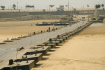 Floating pontoon bridge crossing dry bed of the Yellow River after water has been taken for irrigation.