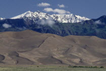 Great Sand Dunes National Monument. Snow capped mountain landscape behind sand dunes