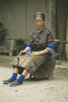 Portrait of woman Miao farmer in traditional dress