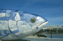 Sculpture of fish next to Lagan Weir footbridge. Designs use Lasertran photocopies of old newspaper clippings.
