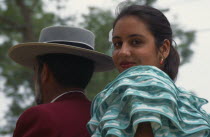 Close shot of couple in traditional dress at Jerez Horse Fair with the woman turned towards the camera.