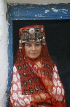 Tajik girl in traditional costume at house on the Silk Route