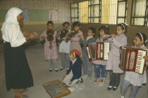 Childrens music lesson in state school