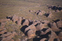 Aerial view over the striped rock towers made up of layers of orange silica and black lichen