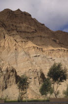 Eroded rocky cliffs above wheat field in a high altitude remote valley near the Yellow River