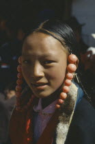 Tibetan girl with coral ornaments around her head