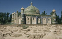 Abakh Hoja Tomb burial place of Hidajetulla Hoja and his decendants. Domed building with green tiles viewed across a dusty graveyard