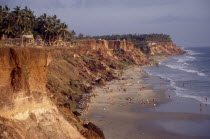 Coastline and sandy beach with bathers sheltered by cliffs