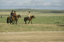 Mongol Horsemen riding through open land