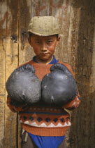 Tibetan boy wearing boxing gloves