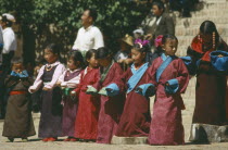 Line of Tibetan girls preparing to dance at festival