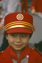 Portrait of young Boy in band wearing red and gold hat