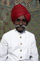 Portrait of a Palace guard dressed in white with a red turban