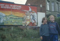 Nationalist mural with young girls stood next with one girl blowing bubblegumBubble GumChewing