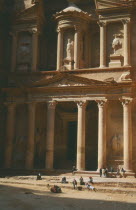 The Treasury with porticoed entrance carved into rock with camel and people in front