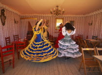 Three young girls in Flamenco dresses dancing in one of the tents at the April Fair